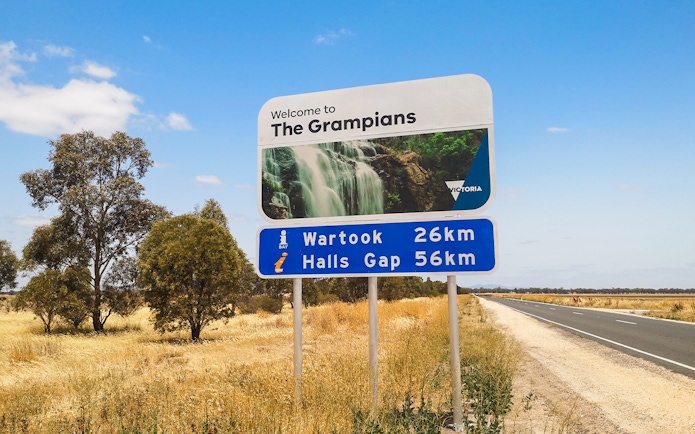 Welcome sign to The Grampians with distance to Wartook and Halls Gap, Australia.