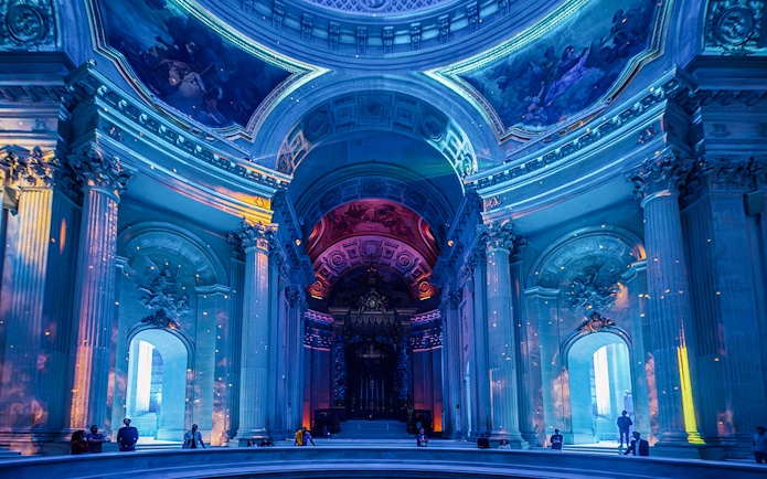 Invalides interior with immersive light display during Aura experience in Paris.
