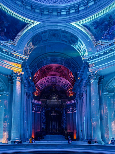 Invalides interior with immersive light display during Aura experience in Paris.