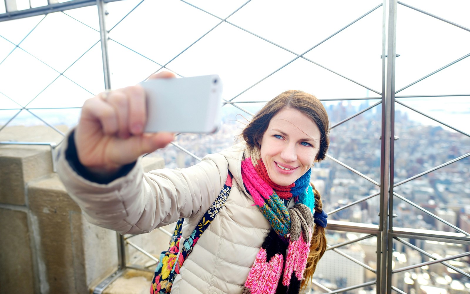 tourist taking selfie at empire state building observation deck