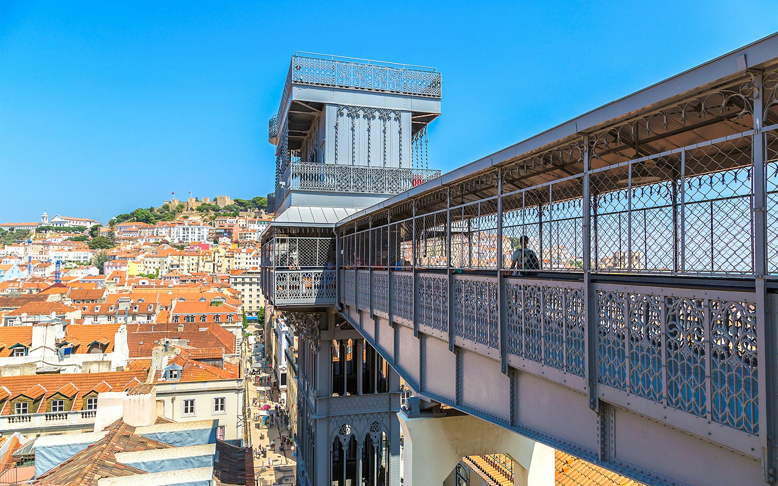 Elevador de Santa Justa in Lisbon with Hop on Hop Off tour bus nearby.