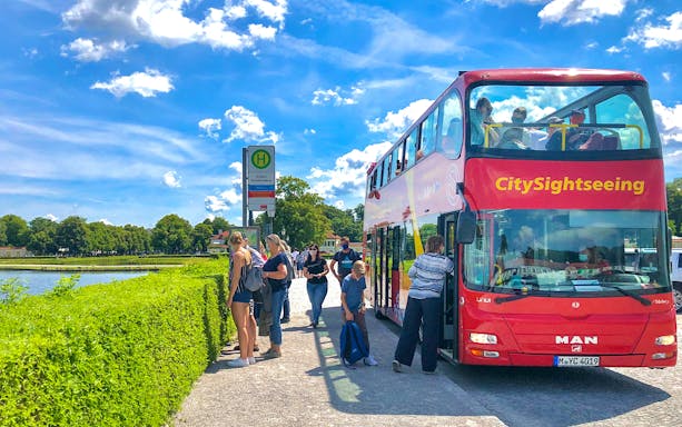 Tourists boarding Citysightseeing bus at Schloss Nymphenburg stop in Munich.
