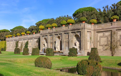 Statues and manicured hedges in the Gardens of Castel Gandolfo, Italy.
