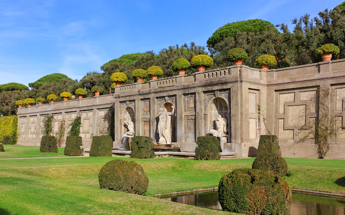 Statues and manicured hedges in the Gardens of Castel Gandolfo, Italy.