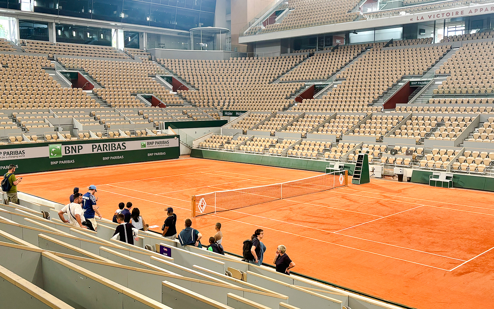 Roland Garros stadium with visitors viewing the Yannick Noah tribute mural.