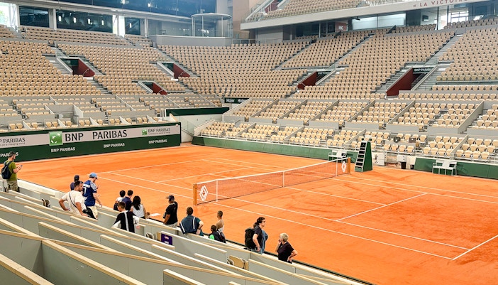 Roland Garros stadium with visitors viewing the Yannick Noah tribute mural.