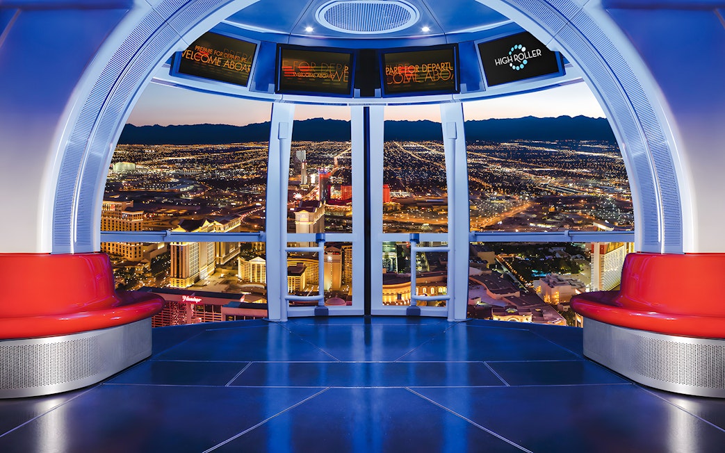 View from High Roller Wheel cabin overlooking Las Vegas skyline at night.