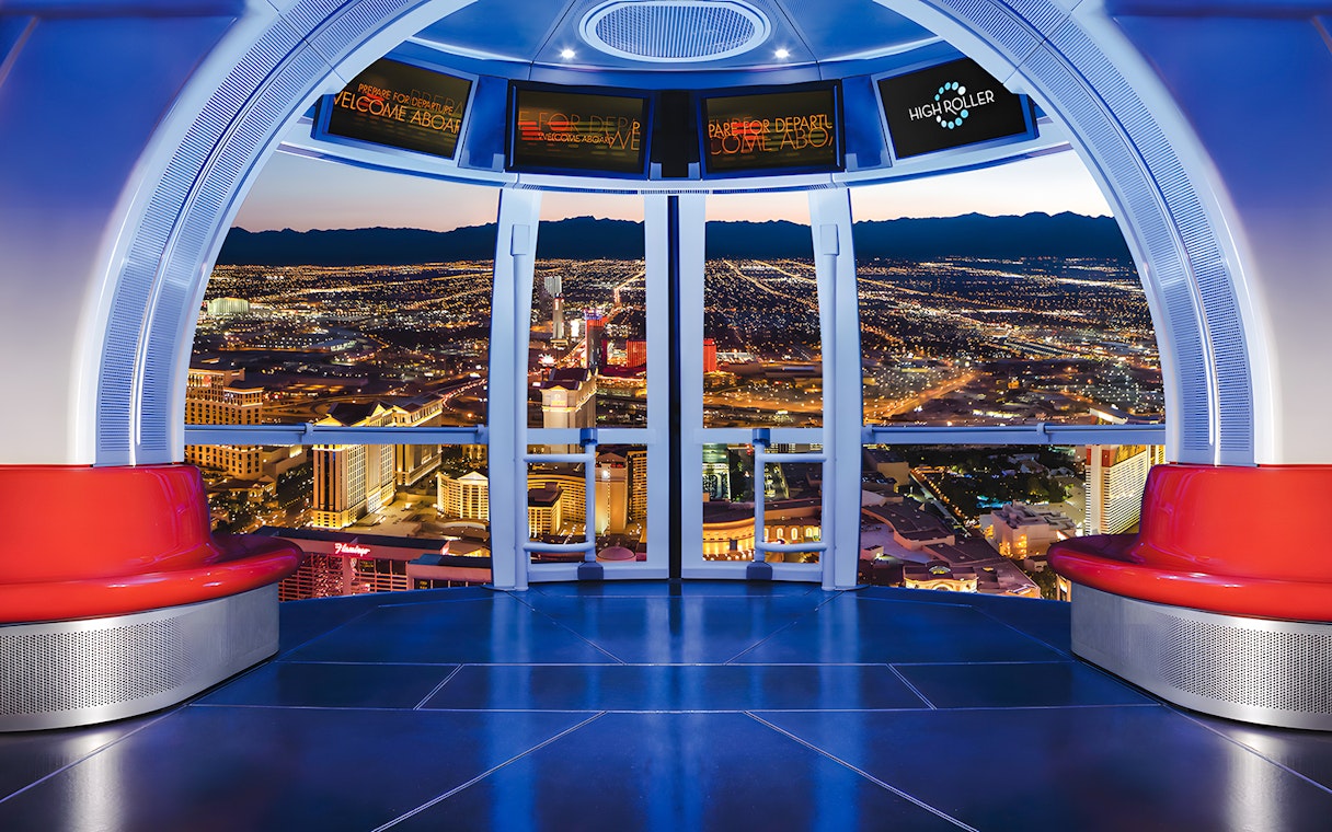 View from High Roller Wheel cabin overlooking Las Vegas skyline at night.