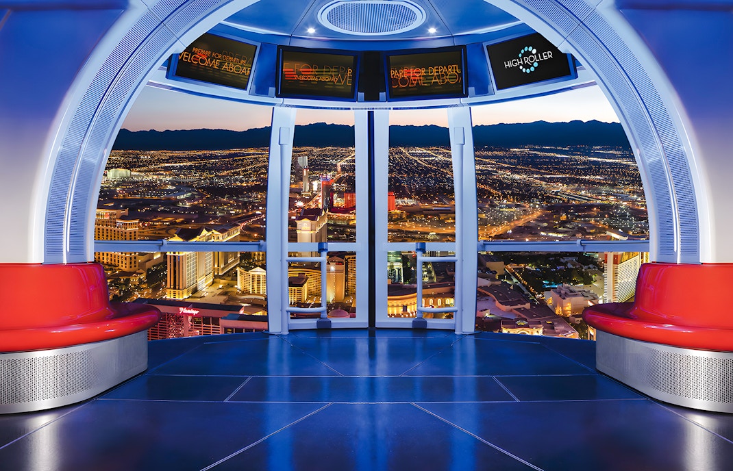 View from High Roller Wheel cabin overlooking Las Vegas skyline at night.