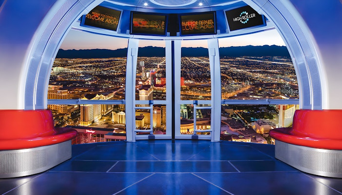 View from High Roller Wheel cabin overlooking Las Vegas skyline at night.