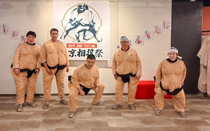 Tourists in sumo suits at Tokyo Sumo Festival in Ginza.