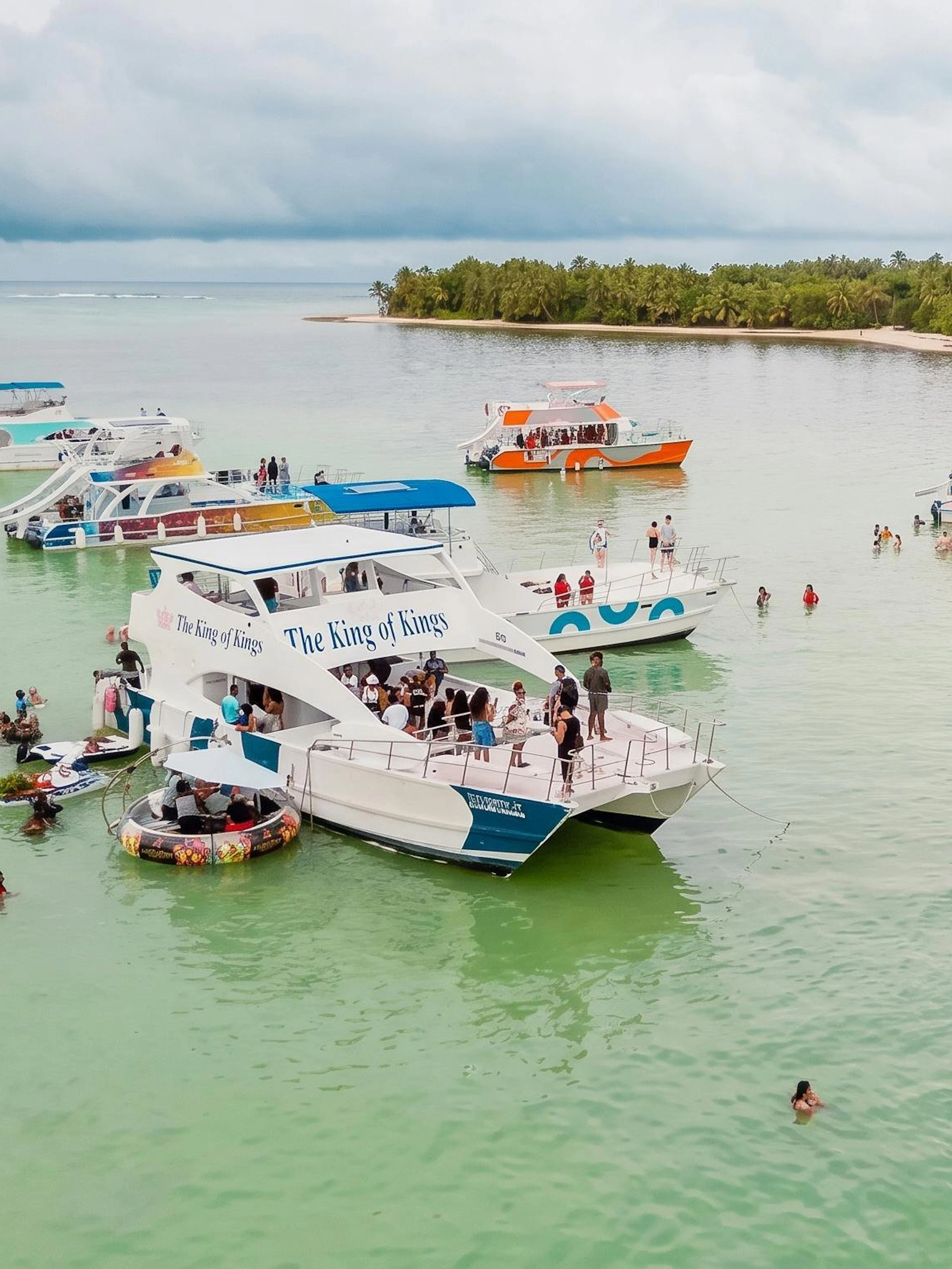 Boat party with snorkeling in the Caribbean Sea near Punta Cana, featuring multiple boats and swimmers.