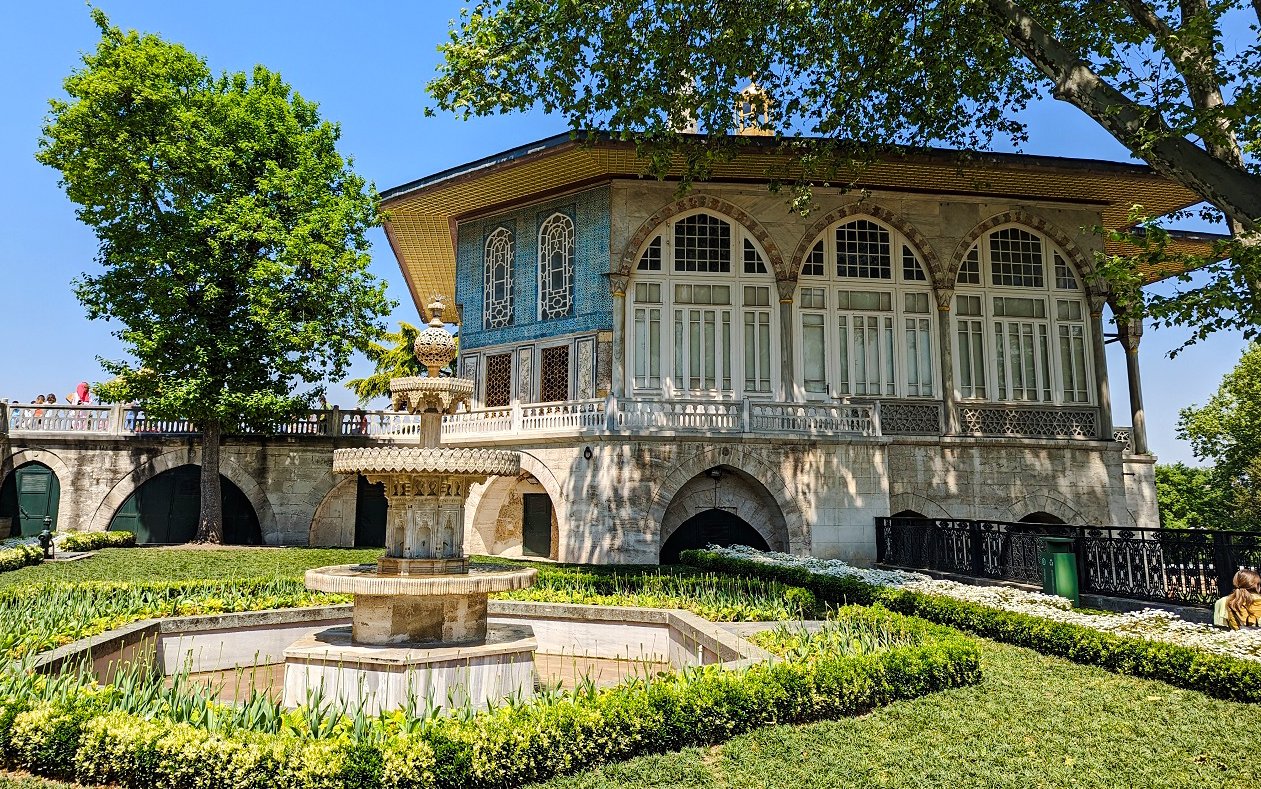 Topkapi Palace courtyard with ornate fountain and historic building in Istanbul.