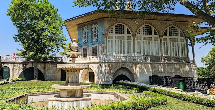 Topkapi Palace courtyard with ornate fountain and historic building in Istanbul.