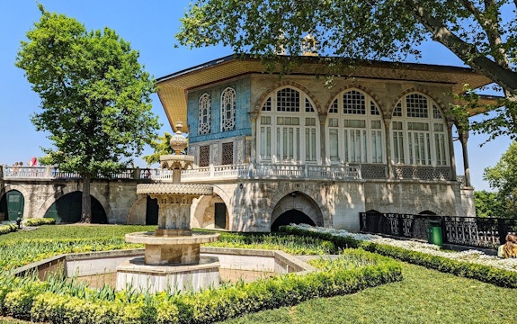 Topkapi Palace courtyard with ornate fountain and historic building in Istanbul.