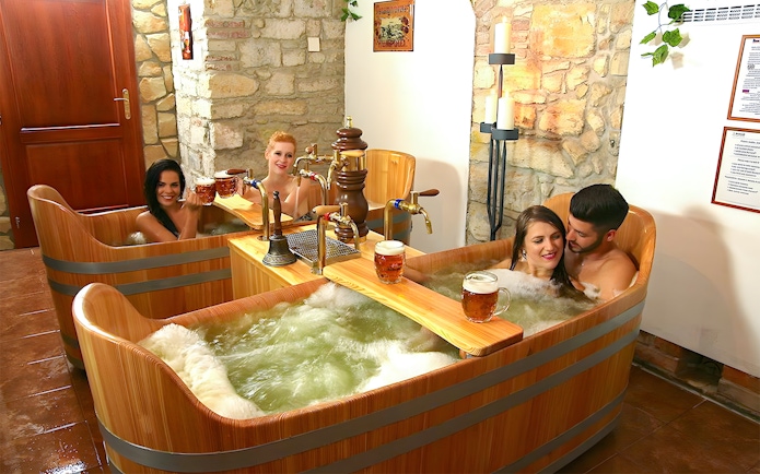 Couples enjoying a beer bath at Bernard Beer Spa.