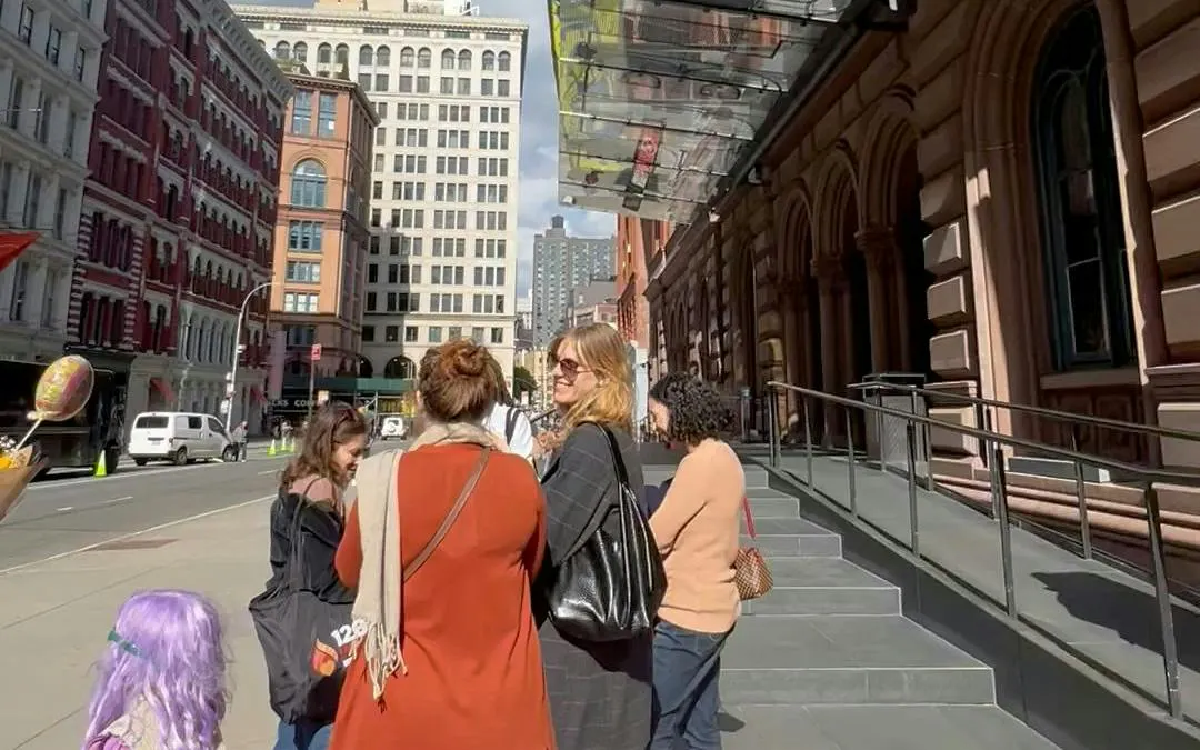 Group exploring New York City street during self-guided Basquiat-themed tour.