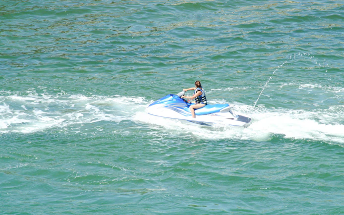 Person riding a jet ski on open water.