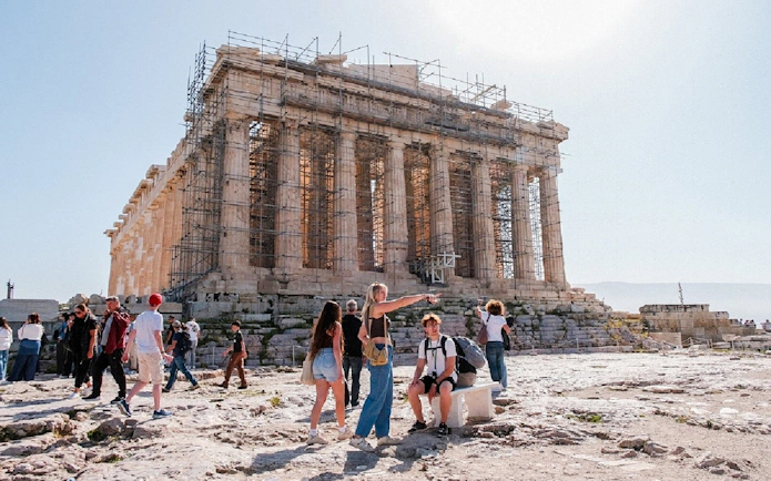 Visitors exploring the Parthenon at the Acropolis in Athens, Greece.