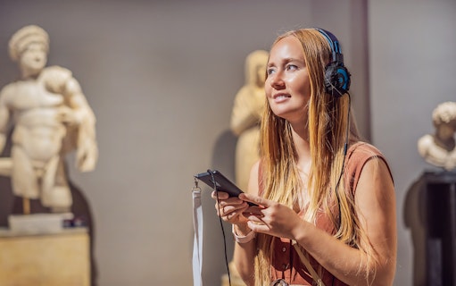 Visitor with audio guide at Acropolis Museum, Athens.