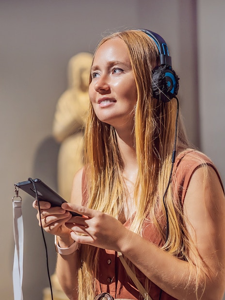 Visitor with audio guide at Acropolis Museum, Athens.