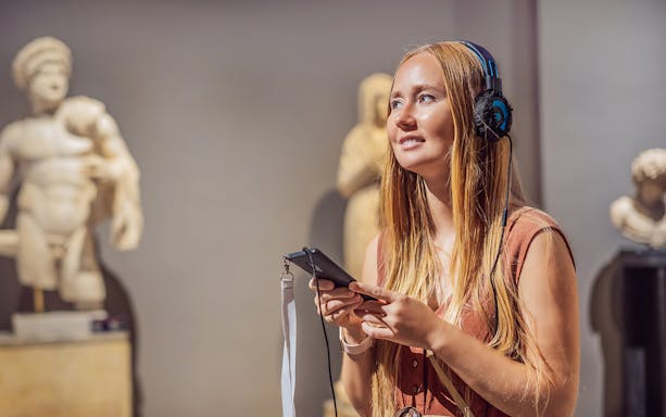 Visitor with audio guide at Acropolis Museum, Athens.