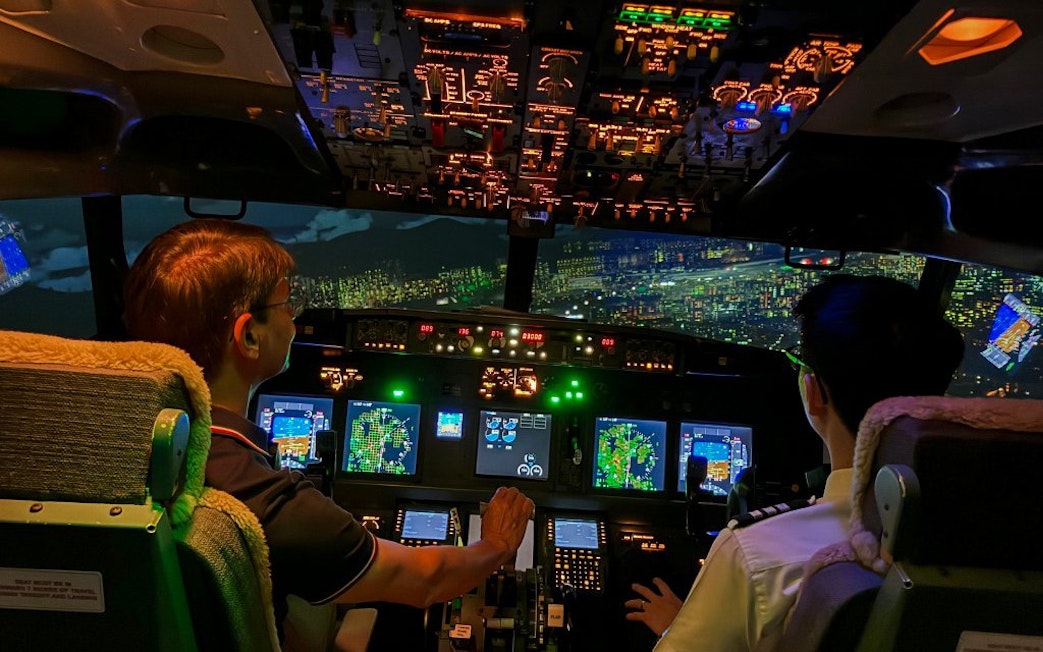 Cockpit view of a Boeing 737 flight simulator experience with pilots navigating.