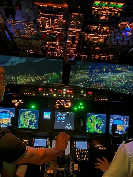 Cockpit view of a Boeing 737 flight simulator experience with pilots navigating.