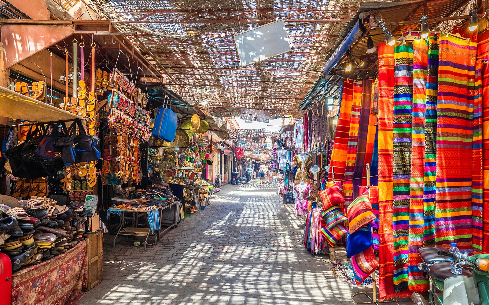 Colorful market stalls with textiles and sandals on Marina Boulevard, Hurghada.