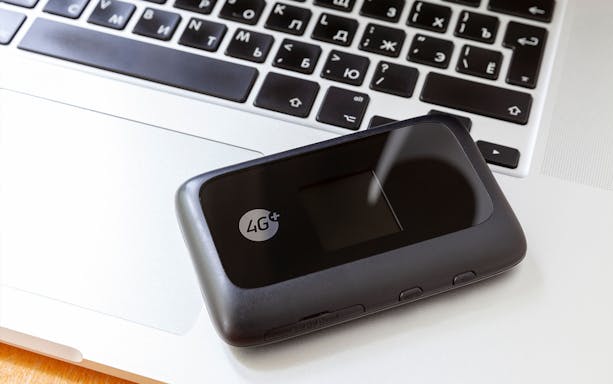 Pocket WiFi device on laptop keyboard for Japan Unlimited WiFi rental.