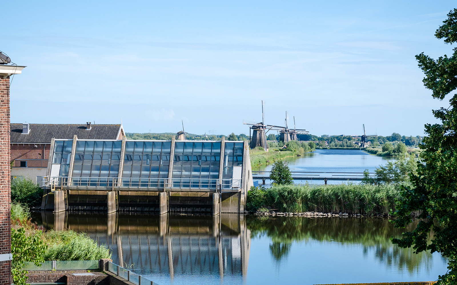 Old Wisboom pumping station with Kinderdijk windmills in the background, Netherlands.