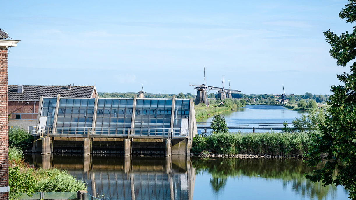 Old Wisboom pumping station with Kinderdijk windmills in the background, Netherlands.