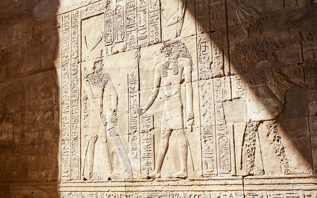 Ancient Egyptian relief sculptures in the Temple of Horus at Edfu.