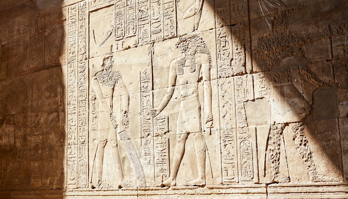 Ancient Egyptian relief sculptures in the Temple of Horus at Edfu.