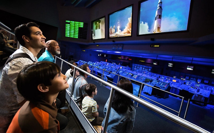 Visitors watching a rocket launch simulation at Apollo Saturn V Center Firing Room.