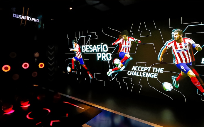 Interactive exhibit at Atletico de Madrid Stadium Tour featuring players in action.