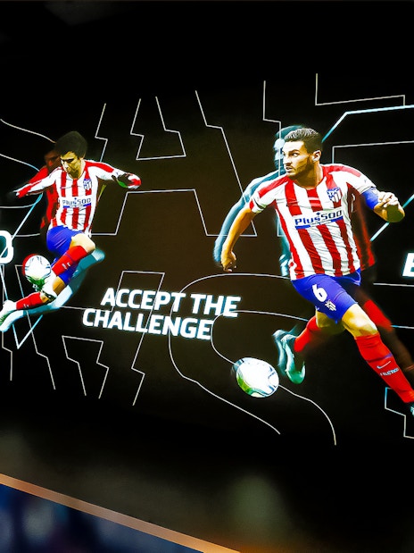 Interactive exhibit at Atletico de Madrid Stadium Tour featuring players in action.
