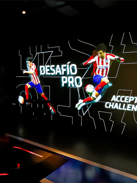Interactive exhibit at Atletico de Madrid Stadium Tour featuring players in action.