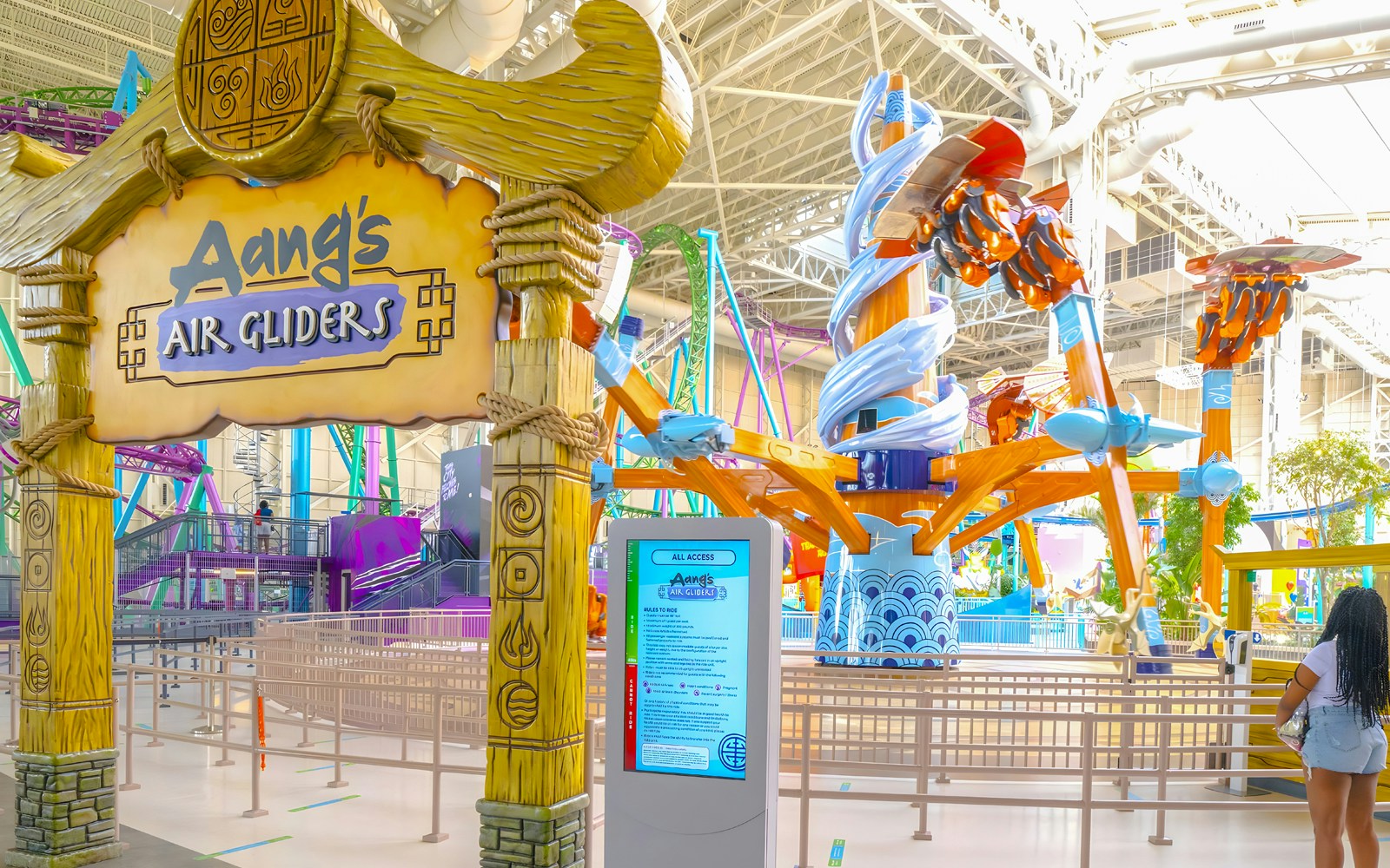 Aang's Air Gliders ride entrance at Nickelodeon Universe, American Dream, featuring colorful structures.