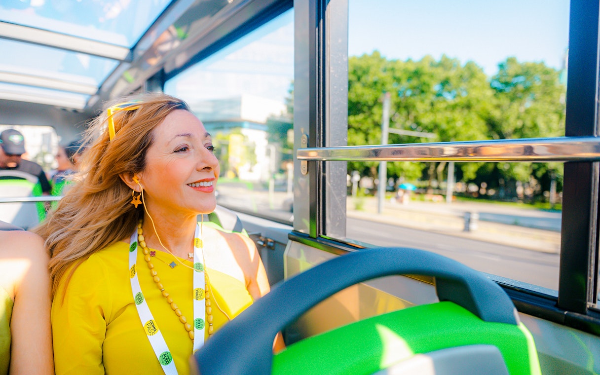 Tourist enjoying a Vienna sightseeing hop-on hop-off bus tour.