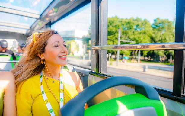 Tourist enjoying a Vienna sightseeing hop-on hop-off bus tour.