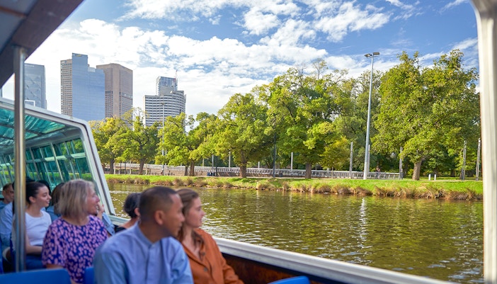 Melbourne River Cruise guests enjoying city skyline views from the boat.