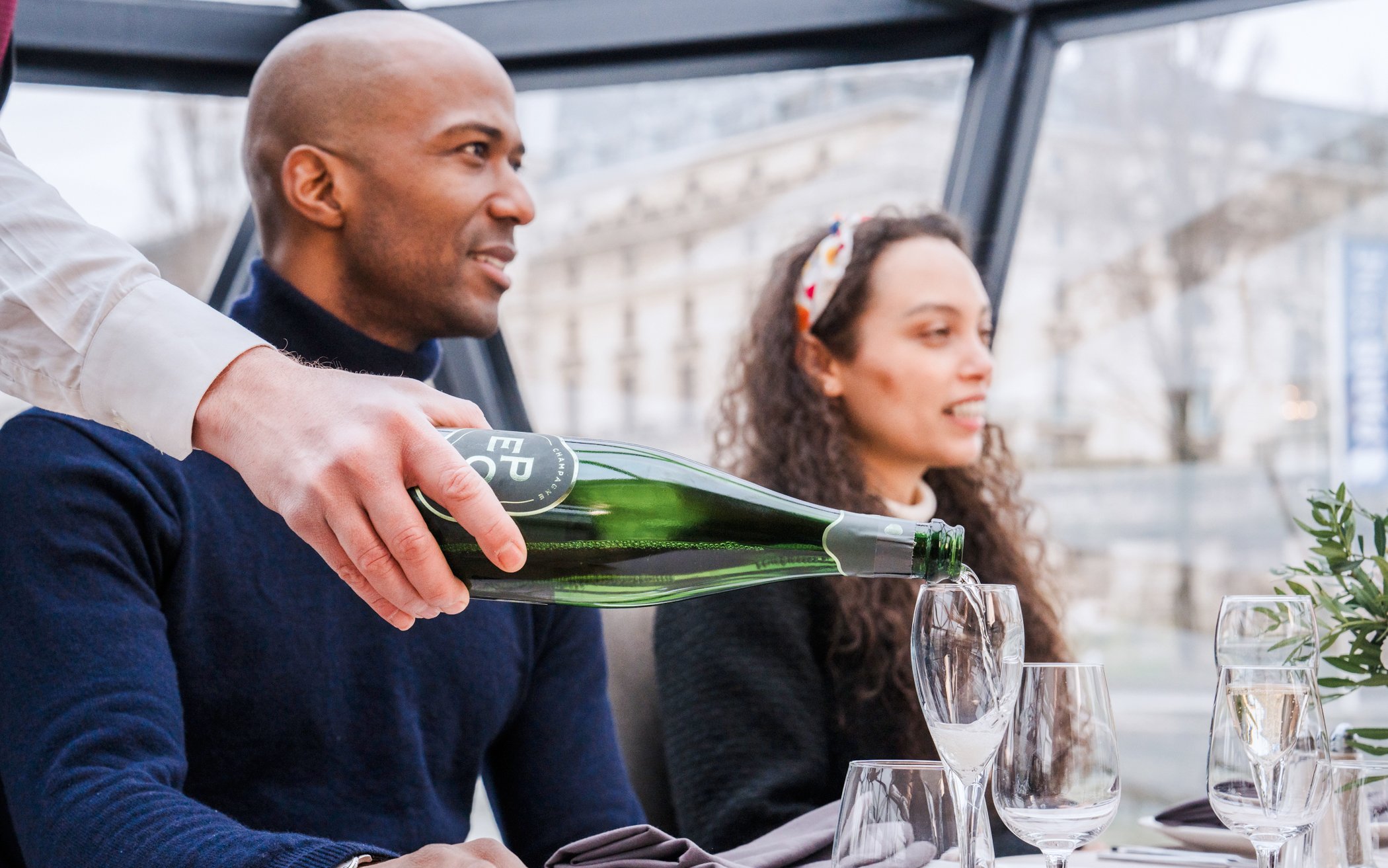 Pouring champagne on Bateaux Mouches Seine River cruise in Paris.