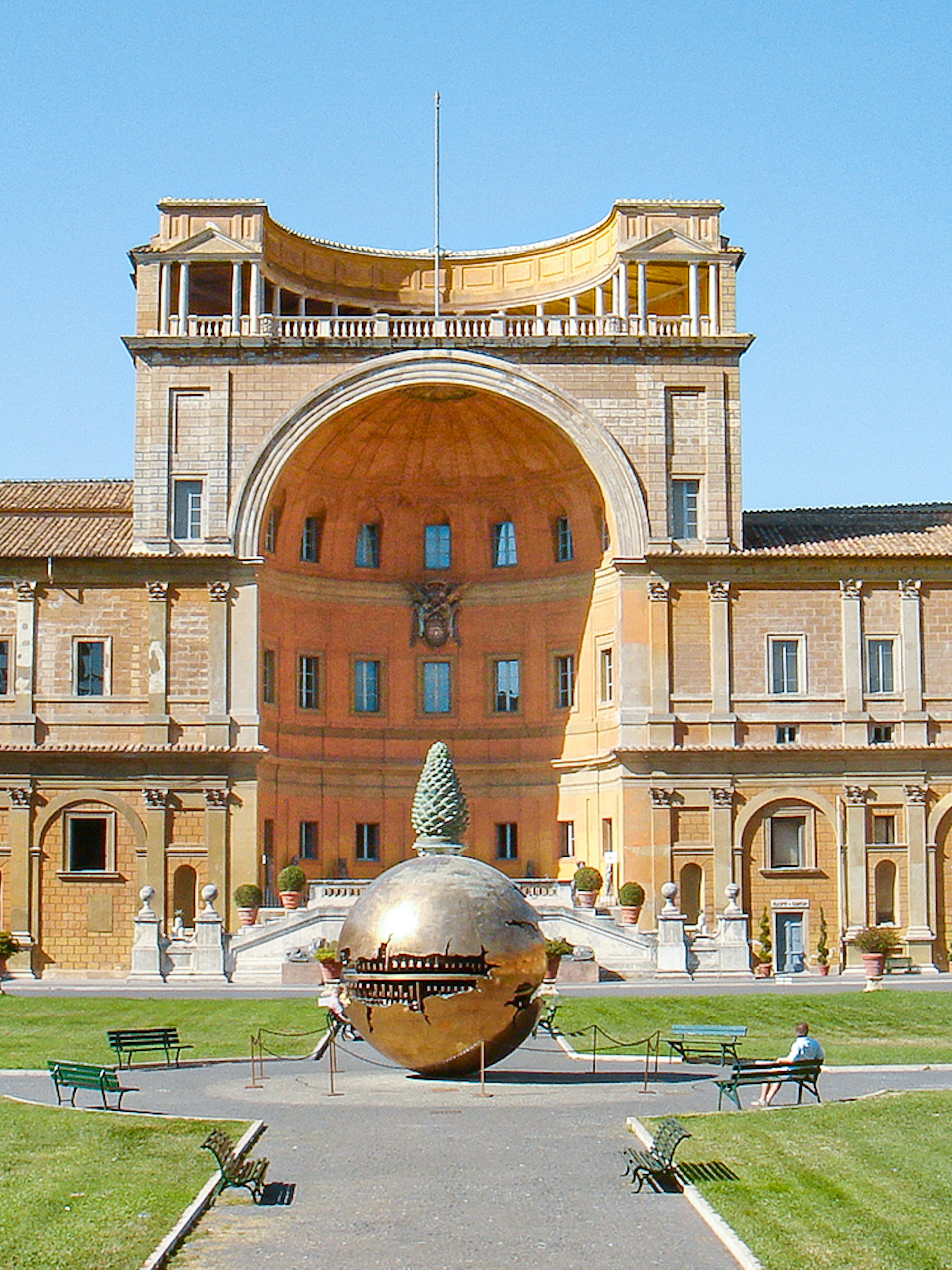 Tourists in Vatican Museums courtyard with Sphere Within Sphere sculpture, Rome, Italy.