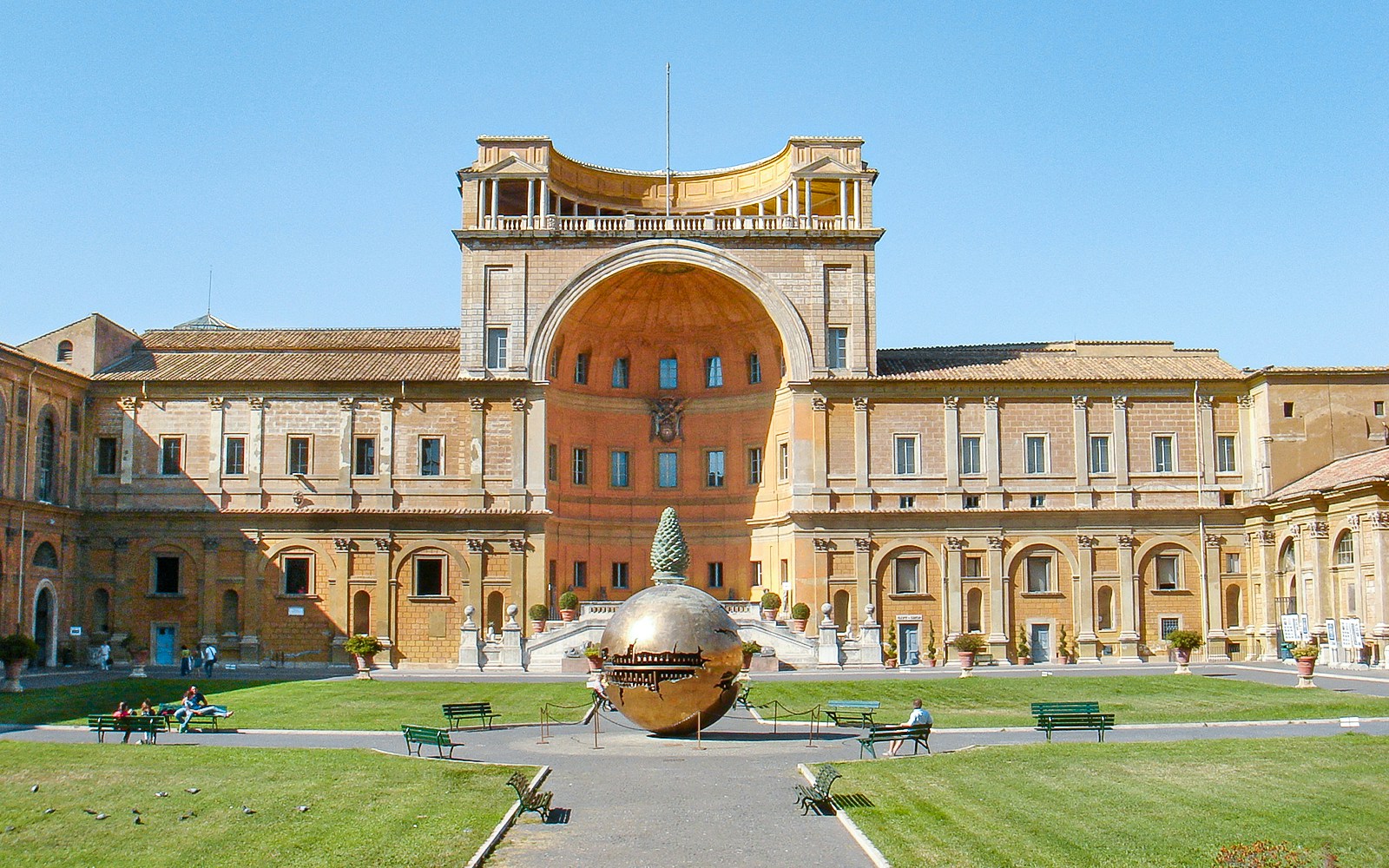 Tourists in Vatican Museums courtyard with Sphere Within Sphere sculpture, Rome, Italy.