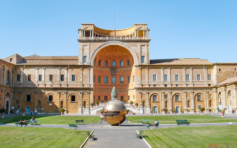 Tourists in Vatican Museums courtyard with Sphere Within Sphere sculpture, Rome, Italy.