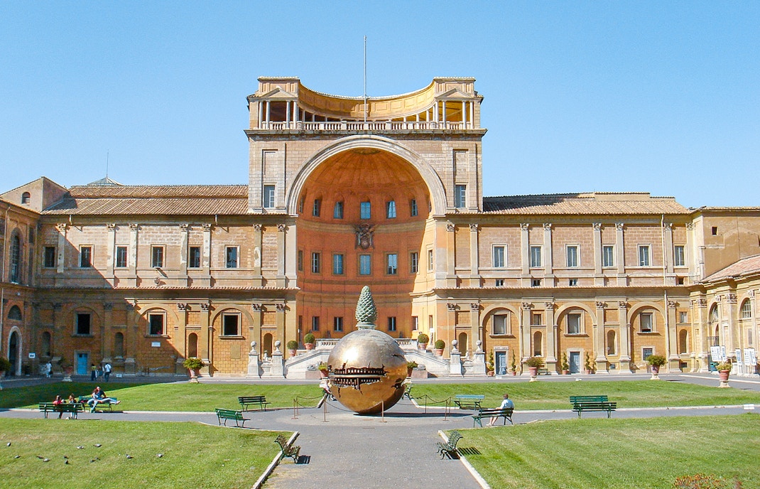 Tourists in Vatican Museums courtyard with Sphere Within Sphere sculpture, Rome, Italy.