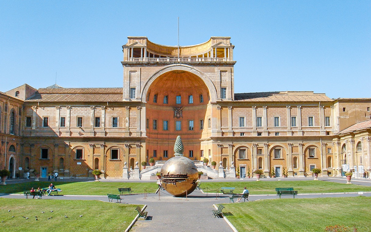 Tourists in Vatican Museums courtyard with Sphere Within Sphere sculpture, Rome, Italy.