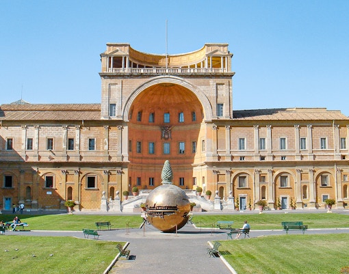 Tourists in Vatican Museums admiring Sistine Chapel ceiling, Rome, Italy, on guided tour.