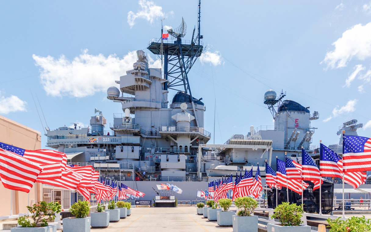 American flags line the walkway to the USS Missouri battleship at Pearl Harbor.